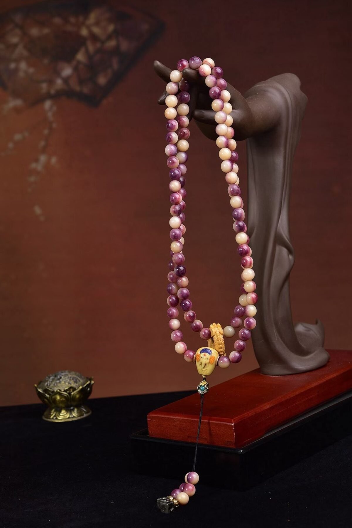 A 108-bead mala on a wooden stand
