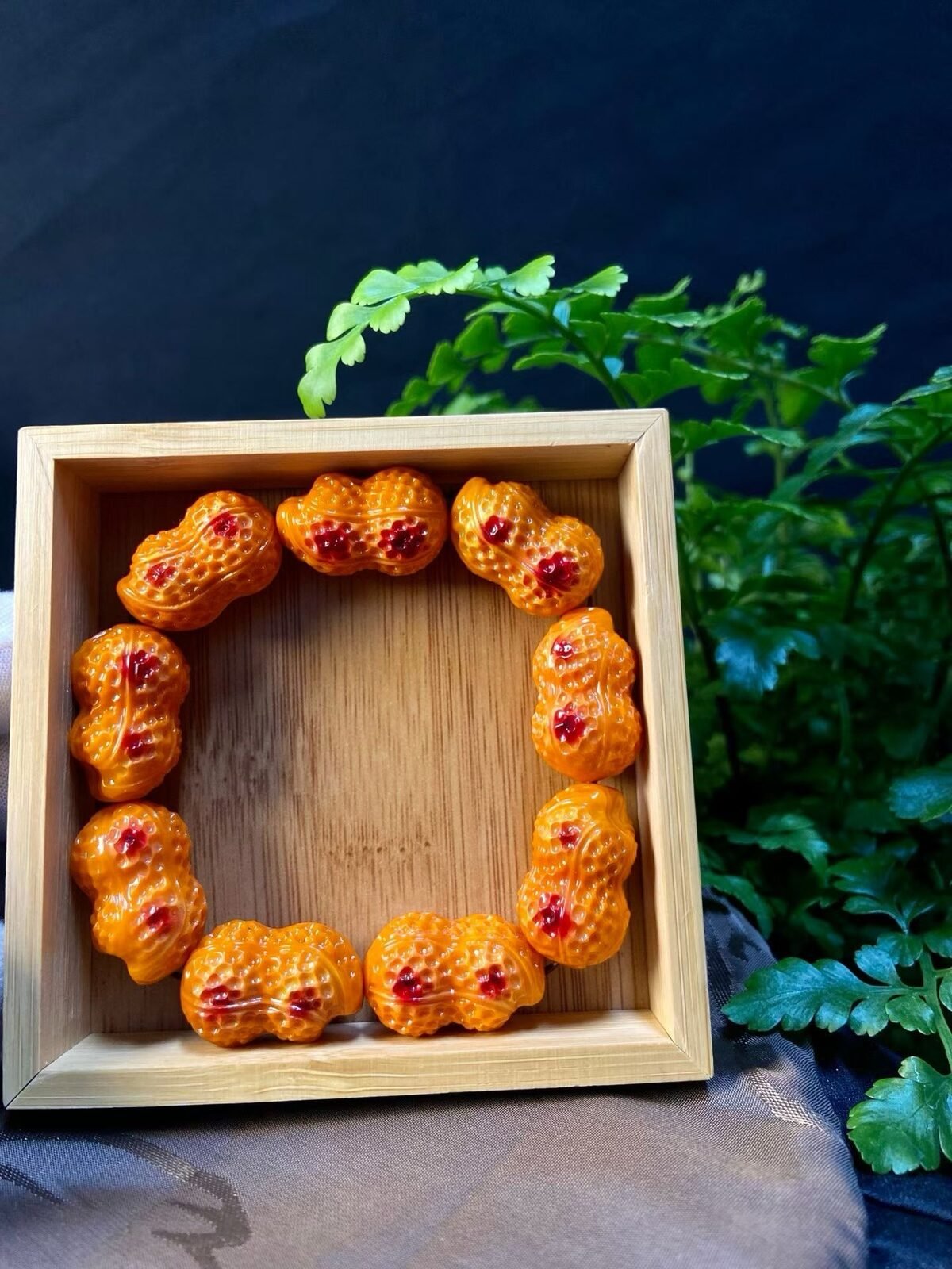 Hand-carved beads resting in a bamboo tray