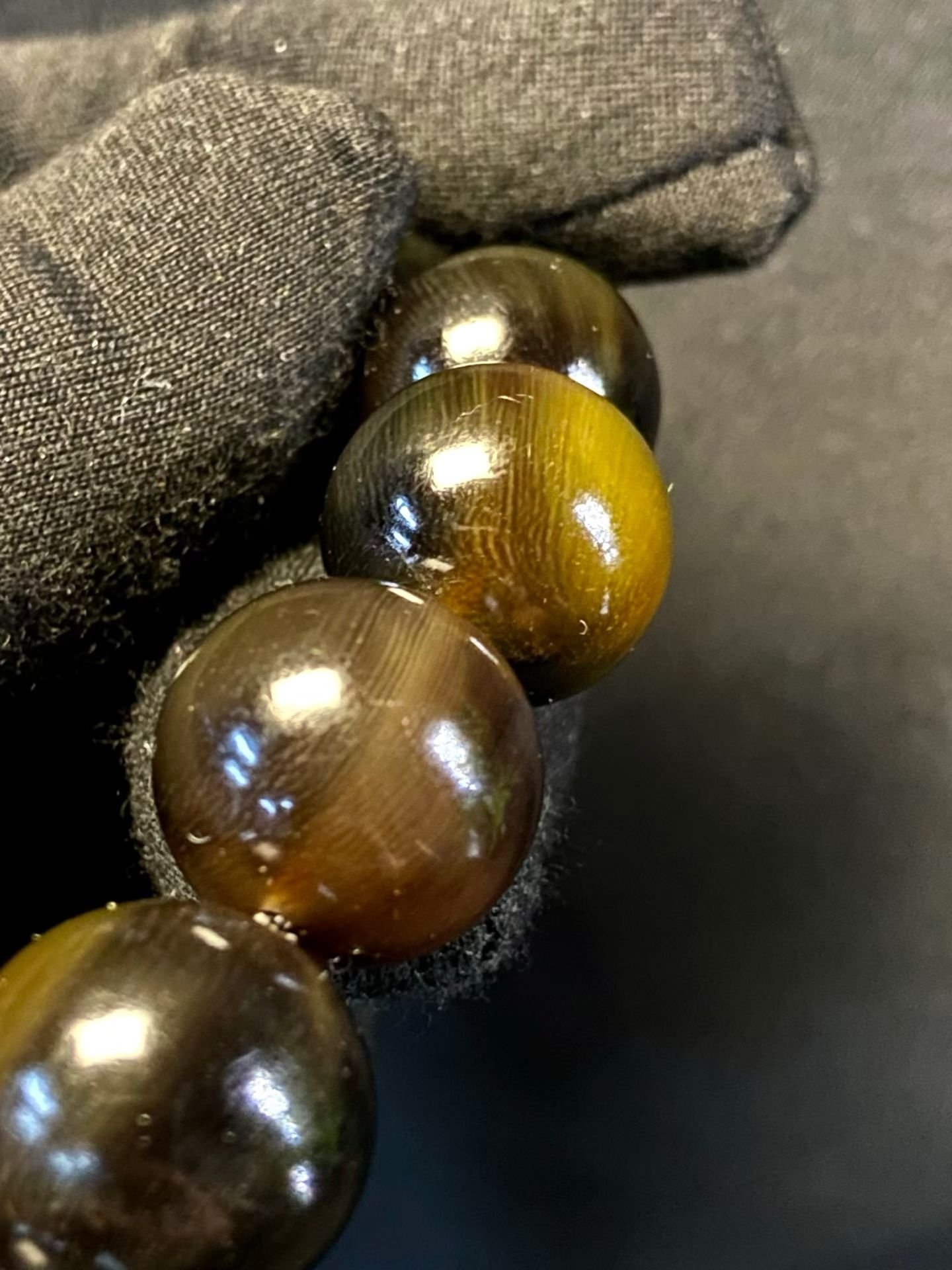 Dark translucent horn beads with a red ring and a pale carved beast head